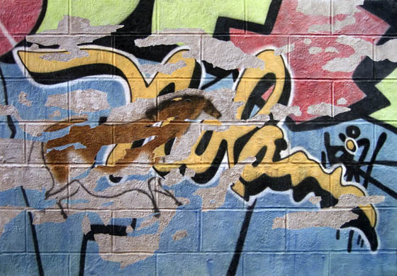 Graffiti tag art competes with Lascaux prehistoric Art in this trompe l’oeil wall art painting by international artist Nolan Haan
